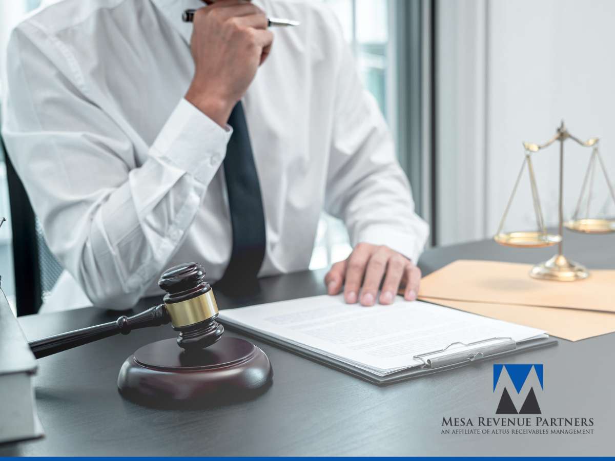 Professional analyzing documents at a desk with gavel and scales, representing ethical Debt Recovery