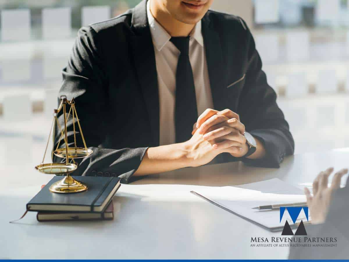 Business professionals discussing financial strategies during an economic downturn, with a gavel symbolizing legal and collection solutions