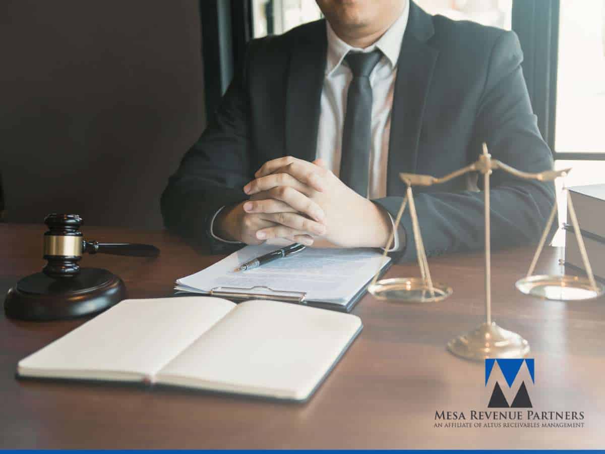 Business professional reviewing AR Aging Reports with legal documents and tools