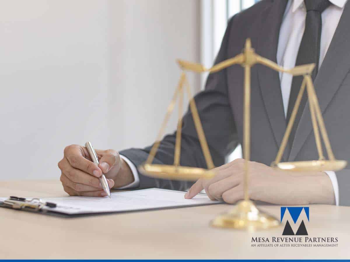 Businessman signing Collection Demand Letters with justice scales on desk